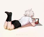  1boy animal_collar artist_name bandaid bandaid_on_arm bandaid_on_knee bandaid_on_leg black_shorts boleum_(dgrpluna) collar danganronpa_(series) danganronpa_2:_goodbye_despair feet_up holding holding_photo komaeda_nagito lying no_shoes on_stomach photo_(object) shirt shirt_tucked_in short_sleeves shorts simple_background socks solo white_background white_shirt 