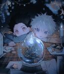  2boys black_hair blue_eyes candle christmas christmas_ornaments cookie food gon_freecss hair_between_eyes highres hunter_x_hunter kiko killua_zoldyck long_sleeves male_focus multiple_boys snow_globe sparkle spiked_hair star_(symbol) table upper_body white_hair 