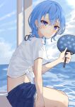  1girl absurdres beach blue_eyes blue_hair blue_nails denim denim_shorts earrings hand_fan highres hololive hoshimachi_suisei jewelry kisara_mikami looking_at_viewer looking_to_the_side midriff nail_polish paper_fan shirt short_hair shorts sitting smile solo tied_shirt virtual_youtuber water white_shirt 