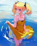  1girl bare_shoulders blonde_hair blue_eyes blue_pupils blue_ribbon breasts cleavage closed_mouth clothes_lift collarbone dress dress_lift furrowed_brow hair_ribbon hand_up highres lifted_by_self medium_hair original ribbon small_breasts solo standing tsukiyono_aroe twintails wading water yellow_dress 