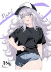  1girl black_shirt blue_eyes blush casual character_name denim denim_shorts goddess_of_victory:_nikke hat highres hormone_nikke long_hair open_mouth poli_(nikke) shirt shirt_tug short_shorts shorts sidelocks smile solo twitter_username very_long_hair wavy_hair white_hair 