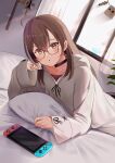  1girl absurdres ahoge axe bed brown_eyes brown_hair casual choker dagger earrings friend_(nanashi_mumei) glasses head_rest highres hololive hololive_english hood hoodie jewelry karu_(karusenpai) knife long_hair looking_at_viewer lying nanashi_mumei nintendo_switch official_alternate_costume on_bed on_stomach parted_lips pillow solo sweater virtual_youtuber weapon 