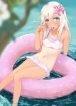  1girl alakoala bikini blonde_hair blue_eyes blurry blurry_foreground bow breasts commentary_request grin hair_between_eyes hair_bow heart heart-shaped_innertube heart_print highres kantai_collection long_hair navel ocean on_innertube one-piece_tan partially_submerged pink_innertube ro-500_(kancolle) small_breasts smile solo spoon swimsuit tan tanlines utensil_in_mouth white_bikini 