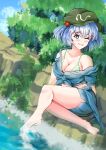  1girl ;d barefoot bikini blue_eyes blue_hair blue_shorts breasts bright_pupils cleavage collarbone commentary full_body ginari green_bikini green_headwear hair_bobbles hair_ornament hat highres kawashiro_nitori large_breasts mob_cap one_eye_closed outdoors short_hair shorts sitting smile solo swimsuit touhou two_side_up white_pupils 
