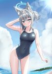  1girl animal_ear_fluff animal_ears ass_visible_through_thighs beach black_one-piece_swimsuit blue_archive blue_eyes blue_sky breasts cloud competition_swimsuit covered_navel cowboy_shot cross_hair_ornament day extra_ears grey_hair hair_ornament halo highres leaning_to_the_side looking_at_viewer low_ponytail medium_breasts medium_hair mismatched_pupils multicolored_clothes multicolored_swimsuit official_alternate_costume one-piece_swimsuit outdoors shiroko_(blue_archive) shiroko_(swimsuit)_(blue_archive) sky solo swimsuit uma_(uma_mohumohu) wolf_ears 