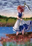  1girl blue_dress blurry blurry_foreground closed_mouth cloud cloudy_sky coin commentary_request dress flower full_body hair_bobbles hair_ornament highres holding holding_scythe kyabekko light_particles obi onozuka_komachi outdoors red_eyes red_hair river sash scythe short_sleeves sky solo spider_lily touhou tree two_side_up 
