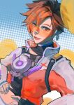  1girl black_gloves brown_hair earrings fingerless_gloves gloves hair_between_eyes hand_on_own_hip highres jacket jewelry le_sserafim midriff official_alternate_costume orange_goggles overwatch overwatch_2 short_hair solo tracer_(overwatch) upper_body westwheat 