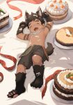  1boy acnhiti animal_ears animal_hands arm_tattoo bed_sheet birthday_cake brown_hair brown_shorts cake commentary english_commentary food food_focus full_body highres kemonomimi_mode male_focus navel open_mouth original short_hair shorts solo tail tattoo wolf_boy wolf_ears wolf_tail 