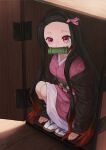  1girl bit_gag black_hair box forehead gag gradient_hair haori highres in_box in_container japanese_clothes kamado_nezuko kimetsu_no_yaiba kimono long_hair mandei_(nao_1234567) multicolored_hair obi pink_eyes pink_kimono red_hair sash solo squatting very_long_hair wooden_box 