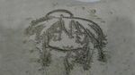  :3 ahoge bean face from_above izumi_konata lucky_star outdoors sand sand_art solo 