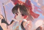  1girl absurdres ascot bare_shoulders black_hair bow cindy717 closed_mouth commentary gohei hair_bow hair_tubes hakurei_reimu highres holding holding_gohei japanese_clothes long_hair looking_at_viewer nontraditional_miko red_bow red_eyes sidelocks solo torii touhou upper_body yellow_ascot 