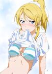  1girl ayase_eli bikini blonde_hair blue_bikini blue_eyes blush breasts clothes_lift highres large_breasts lifted_by_self long_hair looking_at_viewer love_live! love_live!_school_idol_project mouth_hold nagi_mkrnpn navel ponytail shirt shirt_lift short_sleeves solo stomach swimsuit wet wet_clothes wet_shirt white_shirt 
