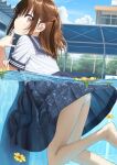  1girl ass barefoot black_sailor_collar black_skirt blue_sky brown_eyes brown_hair cloud commentary_request crotch_seam day flower foot_out_of_frame from_side half_updo hand_up highres long_hair looking_at_viewer looking_to_the_side original outdoors panties pantyshot parted_lips partially_submerged partially_underwater_shot pleated_skirt pool sailor_collar school_uniform serafuku shirt skirt sky solo tsubure_manjuu underwear water white_panties white_shirt yellow_flower 