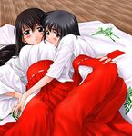  artist_request blush breast_pillow hakama hug japanese_clothes long_sleeves lying miko multiple_girls original red_hakama yuri 