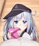  1boy 1girl admiral_(kantai_collection) ahoge anchor_symbol bangs black_hat black_sailor_collar blurry blush box commentary covered_mouth depth_of_field eyebrows_visible_through_hair eyes_visible_through_hair flat_cap from_above gift gift_box hat heart-shaped_box heart_ahoge hibiki_(kantai_collection) highres holding holding_box holding_gift jewelry kantai_collection long_hair long_sleeves looking_at_viewer looking_up pavement pov reitou_mikan ring sailor_collar school_uniform serafuku sideways_hat silver_hair sleeves_past_wrists smile solo_focus valentine wedding_band 