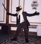  1999 anthrocon anthrocon_1999 canine clothed fox fursuit gloves hat hotel male necktie photo pose real solo speaker suit sword vintage weapon 