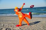  frisbee fur fursuit male meerkat ocean orange orange_fur real sea seaside solo unknown_artist waji water 