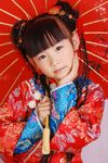  1girl absurdres asian bangs black_hair bun child cosplay double_bun double_buns earrings highres holding japanese jewelry looking_at_viewer parasol photo solo umbrella 