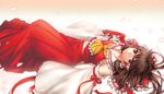  bad_id bad_pixiv_id bow detached_sleeves hair_bow hakurei_reimu irua looking_at_viewer lying midriff on_back petals red_eyes solo touhou 