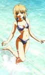  absurdres ahoge artoria_pendragon_(all) barefoot bikini blonde_hair fate/stay_night fate_(series) gentoku green_eyes hair_ribbon highres long_legs navel ocean parted_lips ribbon saber smile solo swimsuit wading water 