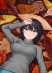  1girl autumn_leaves black_hair blue_eyes breasts hashi large_breasts looking_at_viewer lying minigirl on_back original short_hair solo sweater 