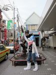  blue car cars city clothing fur fursuit gundam headband japan outside photo real sculpture solo statue 