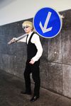  1boy black_pants blonde_hair bow bowtie cosplay durarara!! heiwajima_shizuo heiwajima_shizuo_(cosplay) highres male male_focus pants photo real road_sign sign solo sunglasses vest waistcoat 