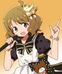 1girl ahoge black_bow black_bowtie blue_eyes blush bow bowtie breasts brooch brown_hair crown dot_nose gradient_background hair_bow hair_ribbon hands_up holding holding_microphone idolmaster idolmaster_million_live! idolmaster_million_live!_theater_days index_finger_raised jewelry kidachi looking_at_viewer microphone mini_crown open_mouth orange_ribbon polka_dot polka_dot_bow puffy_short_sleeves puffy_sleeves ribbon short_hair short_sleeves simple_background small_breasts smile solo star_brooch suou_momoko teddy_bear_ornament two-tone_dress upper_body wavy_hair 