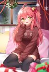  1girl :d ahoge bell black_thighhighs blurry blurry_foreground blush bow christmas gift green_eyes hair_bell hair_between_eyes hair_bow hair_ornament hand_on_own_face hand_up highres hololive hoshino_reiji indoors jingle_bell long_hair long_sleeves looking_at_viewer nail_polish no_shoes one_side_up open_mouth pillow pink_hair pink_nails print_sweater red_bow sakura_miko sitting smile snowing sweater thighhighs turtleneck turtleneck_sweater window yokozuwari zettai_ryouiki 
