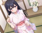  1girl black_hair blue_eyes blush floral_print floral_print_kimono flower hand_up highres indoors japanese_clothes kimono komori_kuzuyu long_hair mimikaki obi pink_nails print_kimono sash sitting smile solo tatami vase 