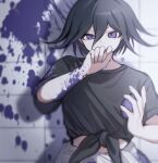  1boy alternate_costume black_hair black_shirt clothes_around_waist commentary covering_own_mouth danganronpa_(series) danganronpa_v3:_killing_harmony flipped_hair hair_between_eyes half-closed_eye hand_over_own_mouth highres looking_at_viewer male_focus oma_kokichi paint_splatter purple_eyes purple_hair shadow shirt short_hair solo symbol-only_commentary tago_(matsu0da) tile_wall tiles upper_body water_balloon 