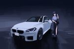  1girl absurdres apollos_ars bag black_hair black_shoes black_skirt bmw bmw_m2 bob_cut car commentary_request grey_shirt highres license_plate long_skirt looking_at_viewer motor_vehicle original shirt shoes shoulder_bag skirt sports_car vehicle_focus white_car 
