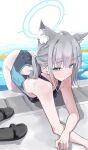  1girl absurdres animal_ear_fluff animal_ears ass black_one-piece_swimsuit blue_archive blue_eyes breasts commentary_request competition_swimsuit cross_hair_ornament eella extra_ears grey_hair hair_ornament halo highres leaning_forward looking_at_viewer low_ponytail lying medium_breasts medium_hair mismatched_pupils multicolored_swimsuit official_alternate_costume on_stomach one-piece_swimsuit ponytail poolside sandals shiroko_(blue_archive) shiroko_(swimsuit)_(blue_archive) smile solo swimsuit unworn_sandals wolf_ears 