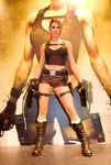  absurdres alison_carroll bike_shorts boots breasts brown_hair cleavage cosplay female fingerless_gloves girl gloves gun lara_croft large_breasts legs long_hair midriff navel photo ponytail shirt shorts socks solo spread_legs standing tomb_raider weapon 