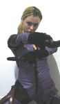  blonde_hair bodysuit capcom cosplay dual_wield dual_wielding gloves gun highres jill_valentine latex looking_at_viewer non-asian photo ponytail real resident_evil resident_evil_5 simple_background solo weapon 