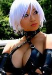  1girl asian black_eyes breasts christie christie_(doa) cleavage cosplay dead_or_alive detached_sleeves earrings jewelry large_breasts leather lowres photo solo tan tan_skin tanned_skin tecmo white_hair yaya_han 