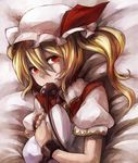  bed blonde_hair chain cuffs flandre_scarlet hat hat_ribbon holding laevatein looking_at_viewer lying manoha_(sawayaka-batake) mouth_hold on_back pillow pillow_hug puffy_sleeves red_eyes ribbon shackles short_hair short_sleeves side_ponytail solo touhou 