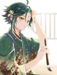  1boy black_hair calligraphy_brush facial_mark forehead_mark genshin_impact green_hair green_kimono hair_ornament highres holding holding_brush japanese_clothes jewelry kimono male_focus multicolored_hair open_mouth paintbrush solo suya_(suya_ny) xiao_(genshin_impact) yellow_eyes 
