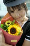  1girl asian bling bouquet brown_eyes brown_hair female flower hat highres jewelry kipi-san necklace photo short_hair smile solo sunflower 