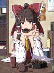  1girl ascot bow brown_hair calendar_(object) commentary_request cup detached_sleeves eating food frilled_bow frilled_hair_tubes frills hair_bow hair_tubes hakurei_reimu highres indoors interlocked_fingers inuno_rakugaki long_hair looking_at_viewer mouth_hold own_hands_together red_bow red_eyes ribbon-trimmed_sleeves ribbon_trim senbei solo steam teapot touhou trash_can yellow_ascot yunomi 