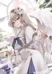  1girl akatsuki_hijiri blonde_hair blue_archive brown_hair commentary_request cup dress flower hair_flower hair_ornament halo hand_up highres holding holding_cup long_hair long_sleeves looking_at_viewer nagisa_(blue_archive) open_mouth signature smile white_dress white_flower wings yellow_eyes 