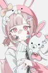  1girl brown_hair collared_shirt cosplay danganronpa_(series) danganronpa_2:_goodbye_despair flipped_hair hair_ornament hashtag-only_commentary highres hood jacket kuma_(id7dug) long_sleeves looking_at_viewer medium_hair monomi_(danganronpa) monomi_(danganronpa)_(cosplay) nanami_chiaki neck_ribbon pink_eyes ribbon shirt solo 