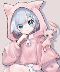  1girl :o animal_hood blue_eyes blush commentary drop_shadow feet_out_of_frame grey_background hair_ornament hairclip hand_up hood hood_up hoodie long_sleeves looking_at_viewer mew_(pokemon) necoyu_(yuyudomino) open_mouth pink_hoodie pokemon pokemon_(creature) shorts simple_background sitting white_shorts 