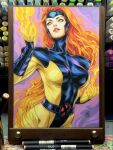  1girl 2025 art_tools_in_frame blue_eyes bodysuit breasts commentary english_commentary fiery_hair fire highres jean_grey large_breasts long_hair looking_up marker_(medium) marvel multicolored_bodysuit orange_hair parted_lips photo_(medium) pyrokinesis red_lips signature skin_tight solo stanley_lau traditional_media two-tone_bodysuit x-men 