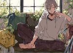  1boy :| barefoot brown_hair closed_mouth commentary_request couch elbow_rest flower hair_between_eyes hood hoodie indoors kankara_nashi leaf male_focus on_couch original pants plant shirt short_hair sitting solo unworn_clothes white_hoodie window 