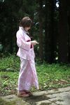  1girl dress floral_print japanese_clothes kimono kouya_(model) lace-trimmed_dress obi outdoors photo pink_dress platform_footwear print_dress print_kimono sandals sash side_ponytail solo standing tree yukata 