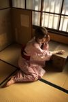  1girl barefoot bracelet dress floral_print indoors japanese_clothes jewelry kimono kouya_(model) lace-trimmed_dress leaning obi on_floor photo pink_dress print_dress print_kimono sash side_ponytail sitting solo table window yukata 