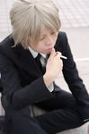  akira_(model) black_necktie black_suit cigarette cosplay crossdressing crossplay formal gokudera_hayato gokudera_hayato_(cosplay) kateikyoushi_hitman_reborn katekyo_hitman_reborn! necktie outdoors photo silver_hair sitting solo suit tie white_shirt 