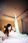  1girl asian bed bedroom highres indoors looking_at_viewer nagasawa_nao pajama_bottoms photo tank_top 
