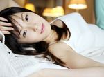  1girl asian bed highres looking_at_viewer nagasawa_nao pajama_bottoms photo tank_top 